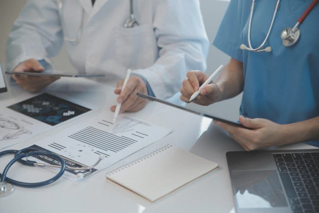 Healthcare professionals reviewing medical records together